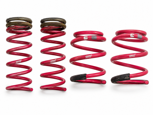 STI genuine cherry pink lowering coil springs set of four, cleaned studio hero showing actual used springs