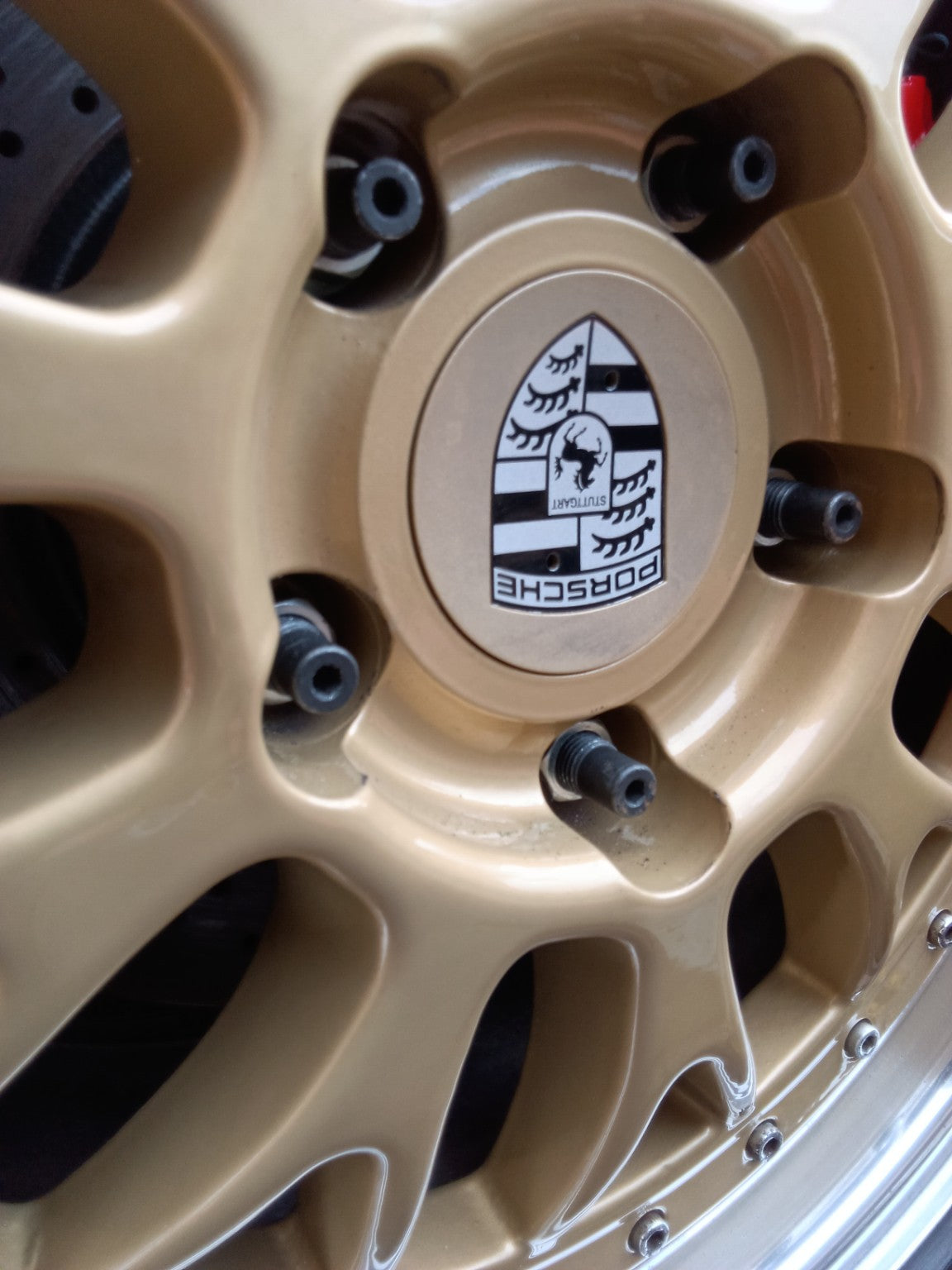Detailed view of PSR9Line Porsche wheel studs installed through alloy wheel